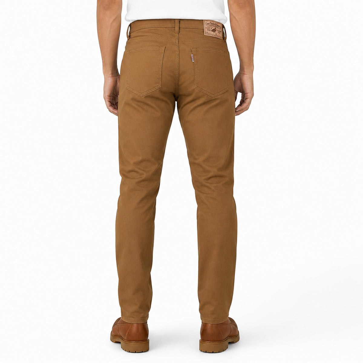 A man viewed from the back wearing brown Levis slim-fit jeans, a white t-shirt, and brown leather shoes, set against a plain white studio background.
