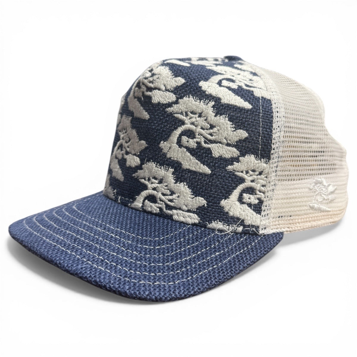 Blue and white floral patterned trucker hat on a white background