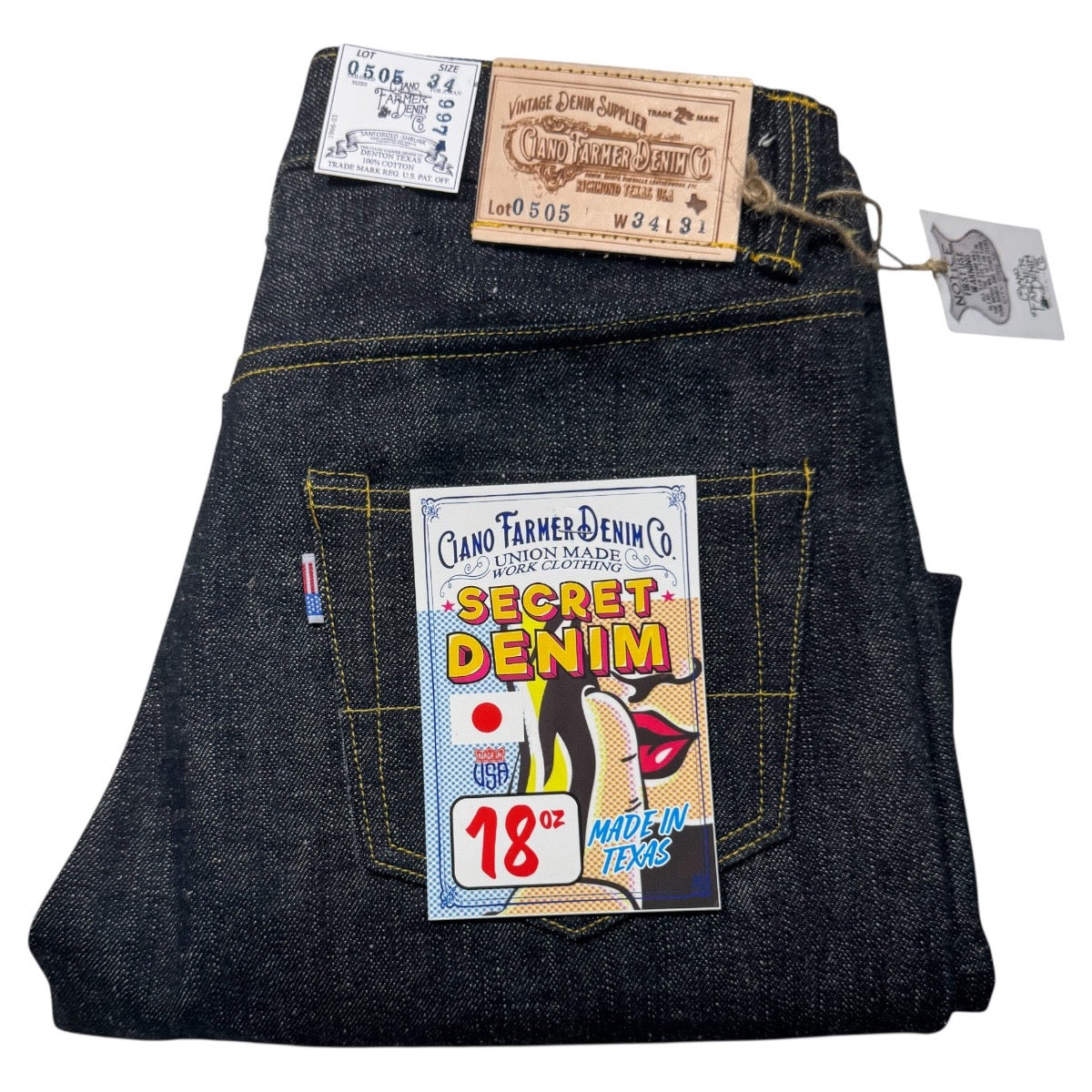 Folded pair of jeans with brand tags and a 'Secret Denim' label on a white background