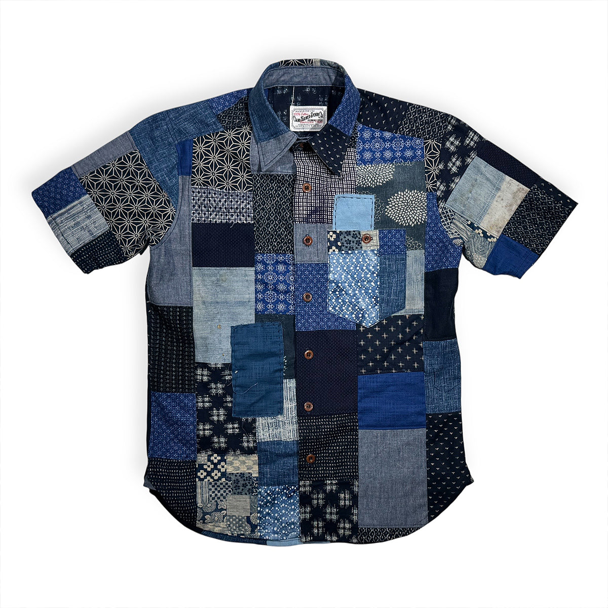 Patchwork shirt with blue and gray patterns on a white background