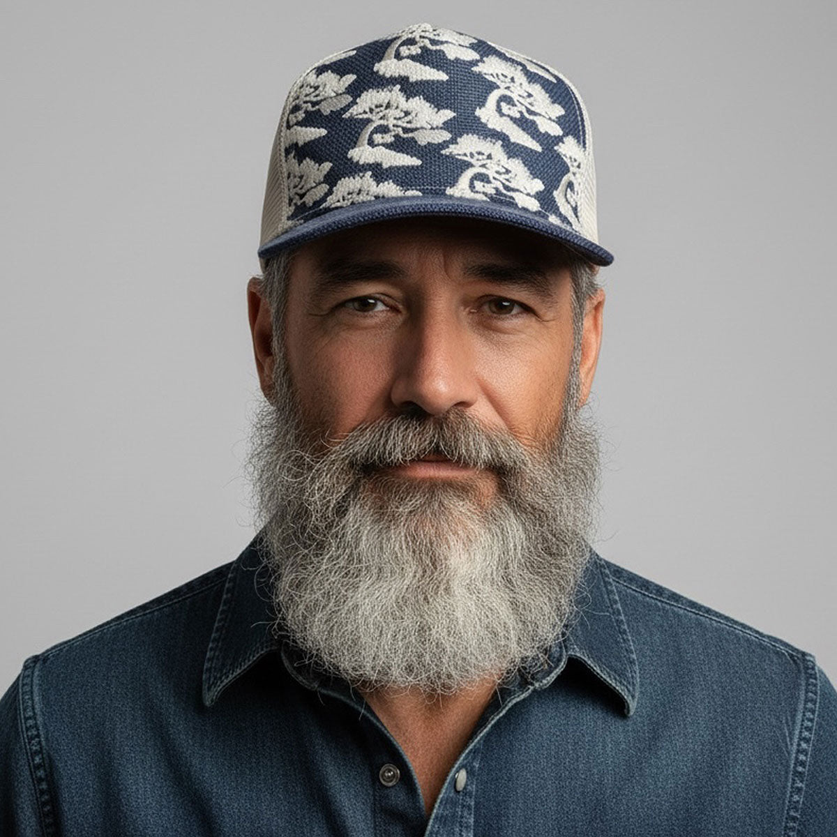Man wearing a cap with a pattern on a gray background